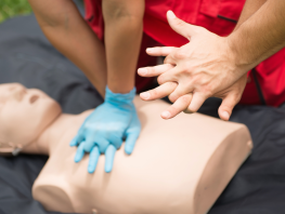 A CPR dummy with clasped hands. 