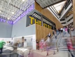 Image of college entrance with students blurred. 