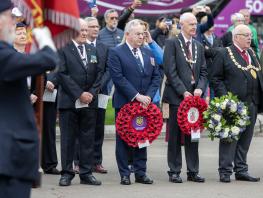 Principal Paul Little holding the City of Glasgow College wreath 