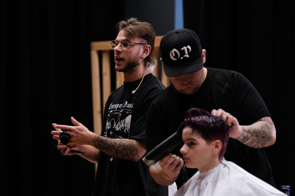 Barber.josh.o.p trainers demonstrating cutting techniques on stage at City campus