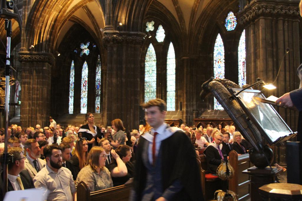 Student walking across the stage during the graduation ceremony