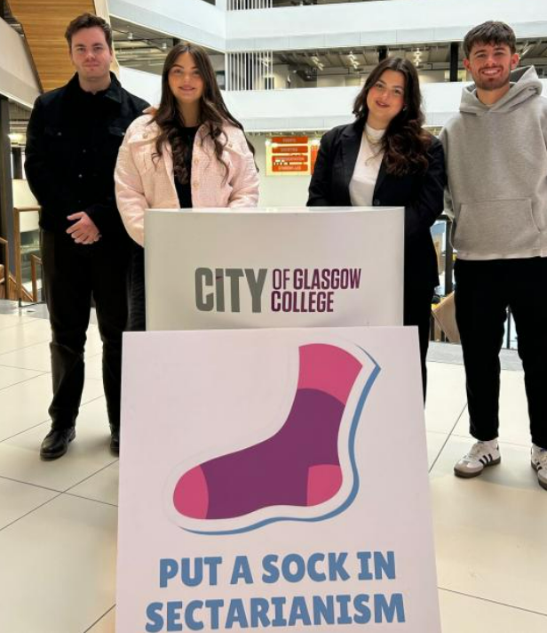 Four marketing students stand with their campaign poster (Image: Nil by Mouth)