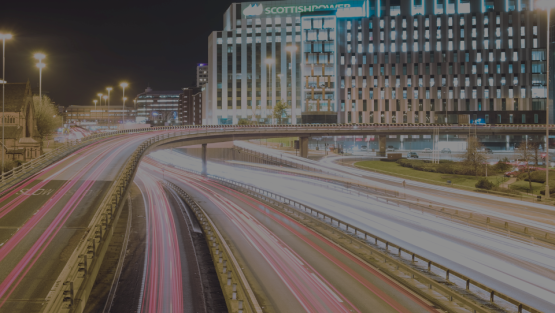 A night time view of the motorway and the financial district in Glasgow.