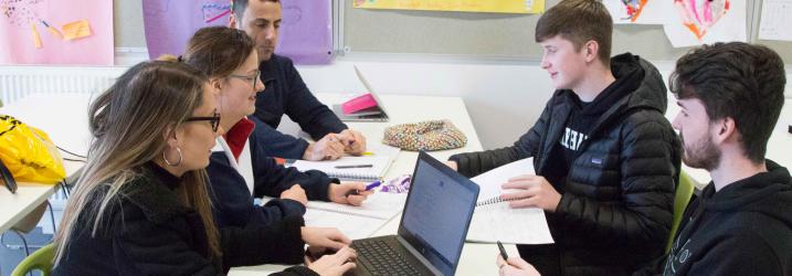 Students working in laptop in classroom at City campus.