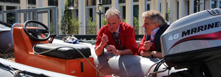 Lecturers working on one of a training dinghy.