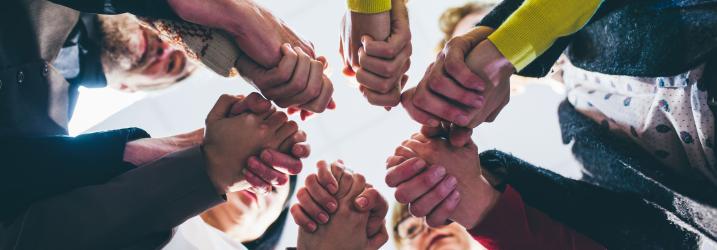 A circle of people holding hands.