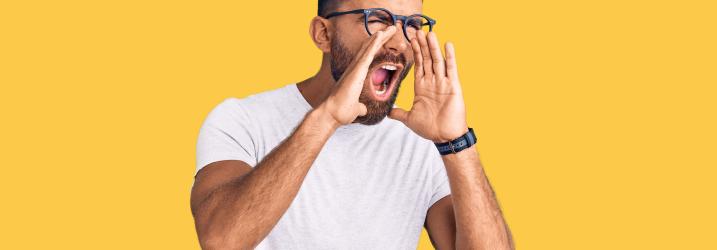 Man holding his hands up to his mouth shouting