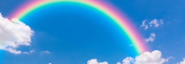 Blue sky, white clouds and a rainbow