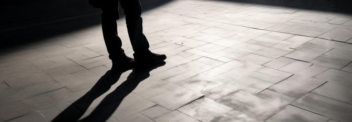 Dark shadow of a person on the ground in the street