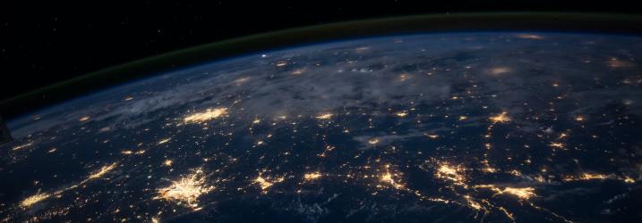 View of the earth at night from space with lights.