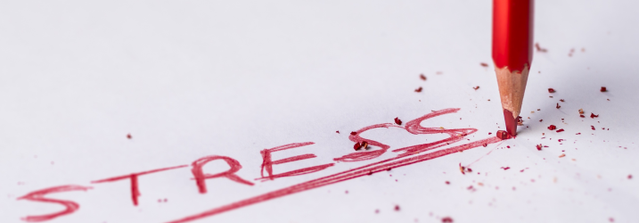 white paper with the word stress written on it in red pencil